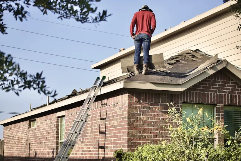 Professional roofer working on a residential roof in Copperhill